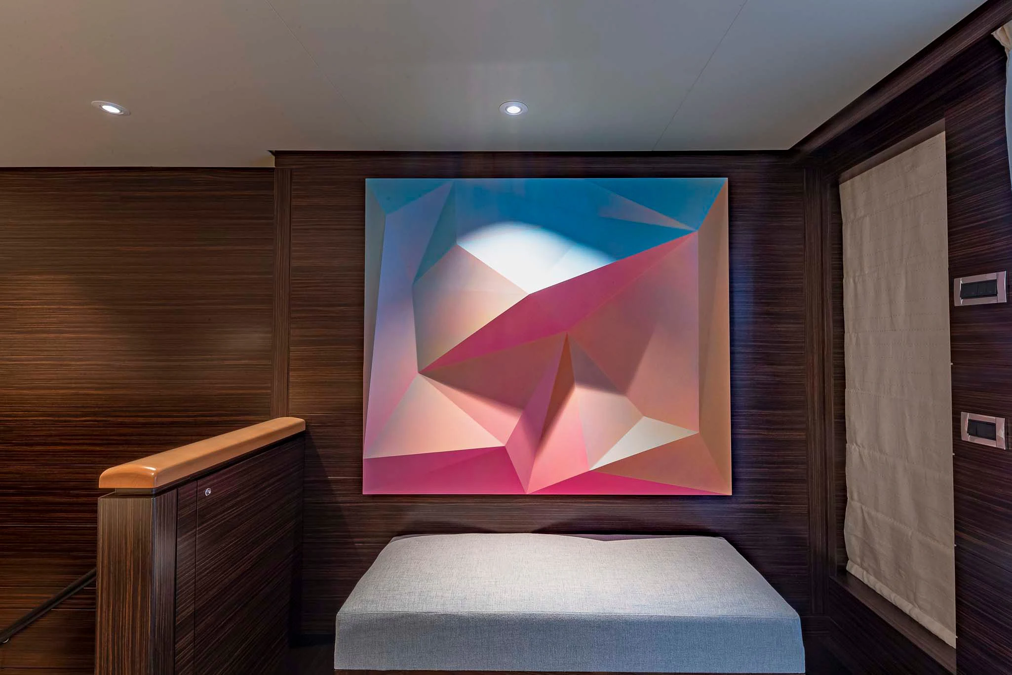 a room with a couch and a painting on the wall aboard REVELRY Yacht for Sale