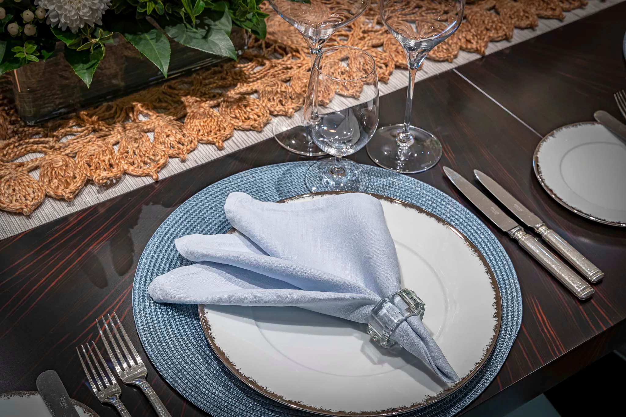 a plate with a napkin and glasses on it aboard REVELRY Yacht for Sale