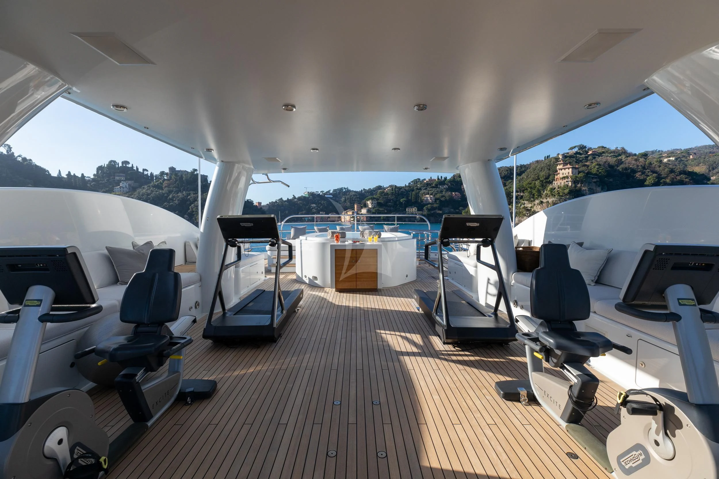 a large white tent with a deck and a pool table and chairs aboard REVELRY Yacht for Sale