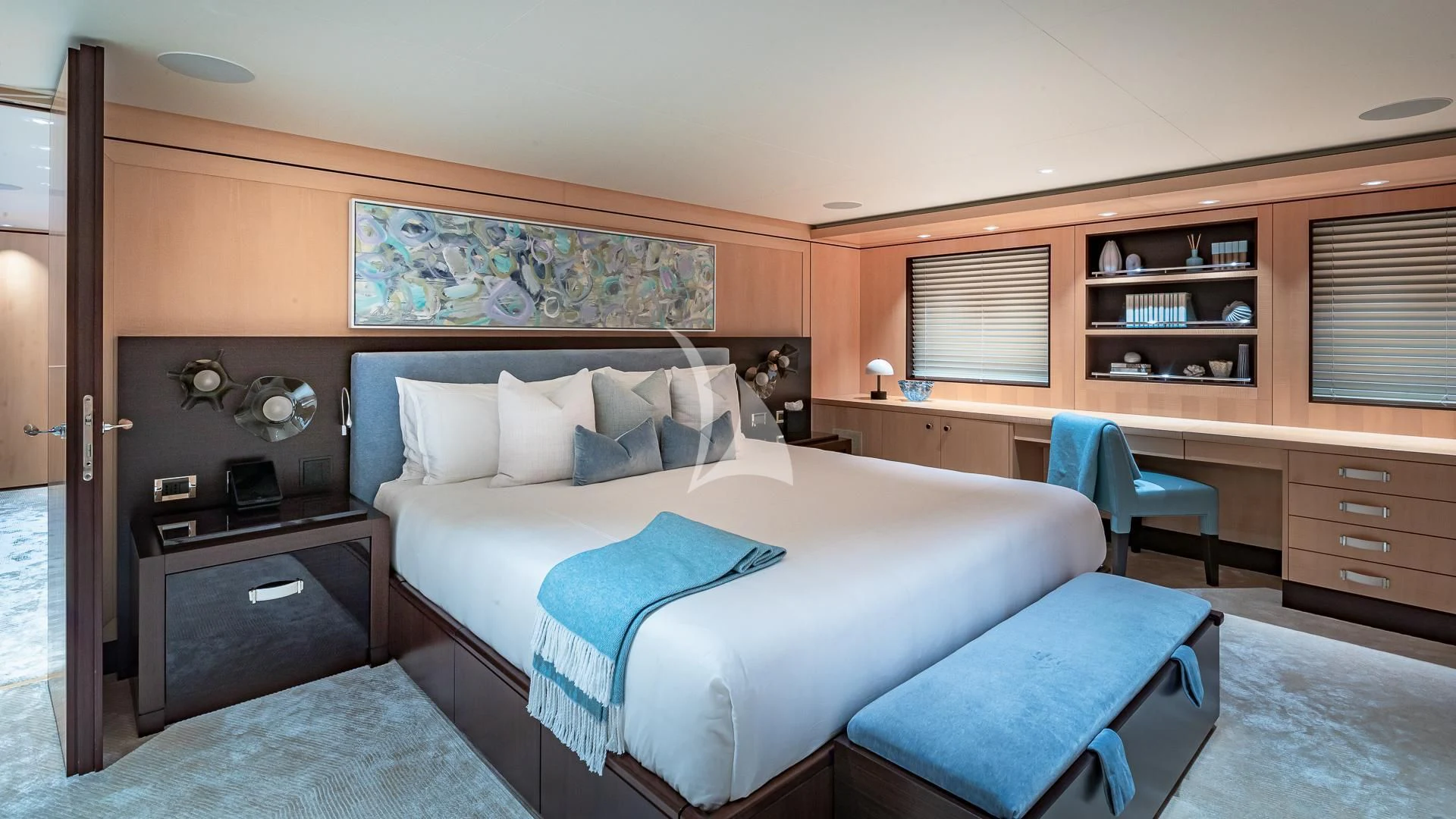 a bedroom with a bed and a desk aboard REVELRY Yacht for Sale