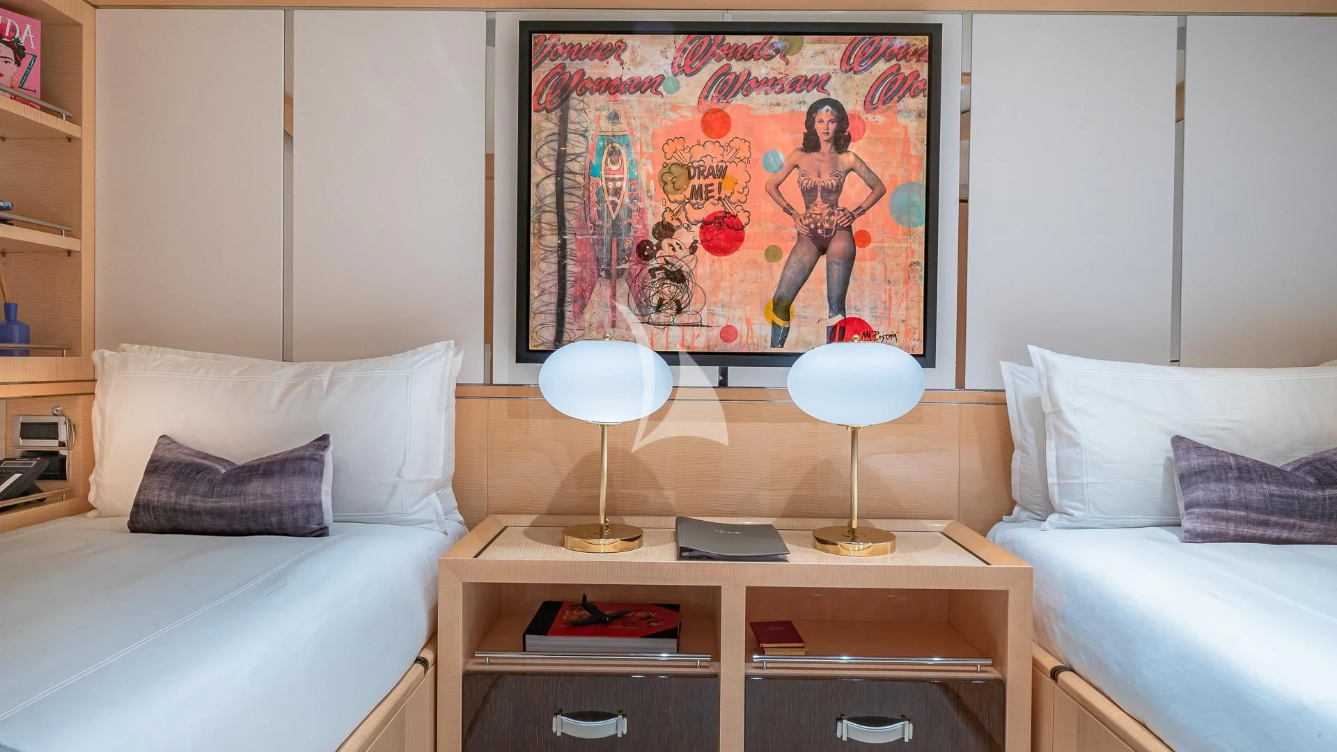 a room with a bed and a desk with a lamp on it aboard REVELRY Yacht for Sale