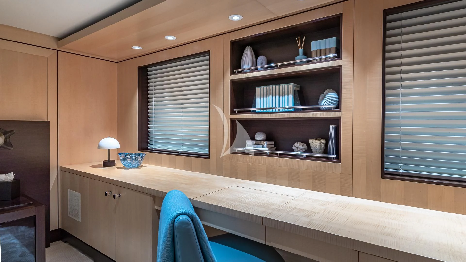 a kitchen with a blue chair aboard REVELRY Yacht for Sale