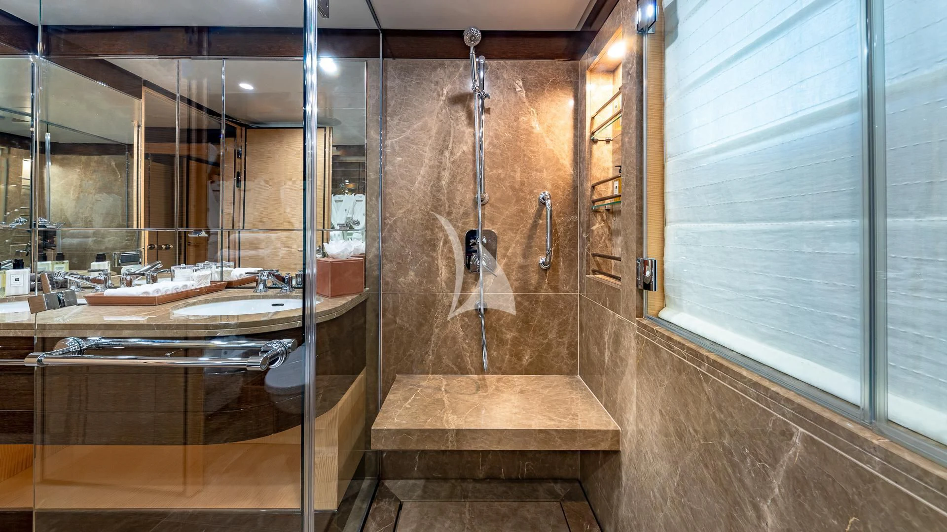 a bathroom with a shower and sink aboard REVELRY Yacht for Sale