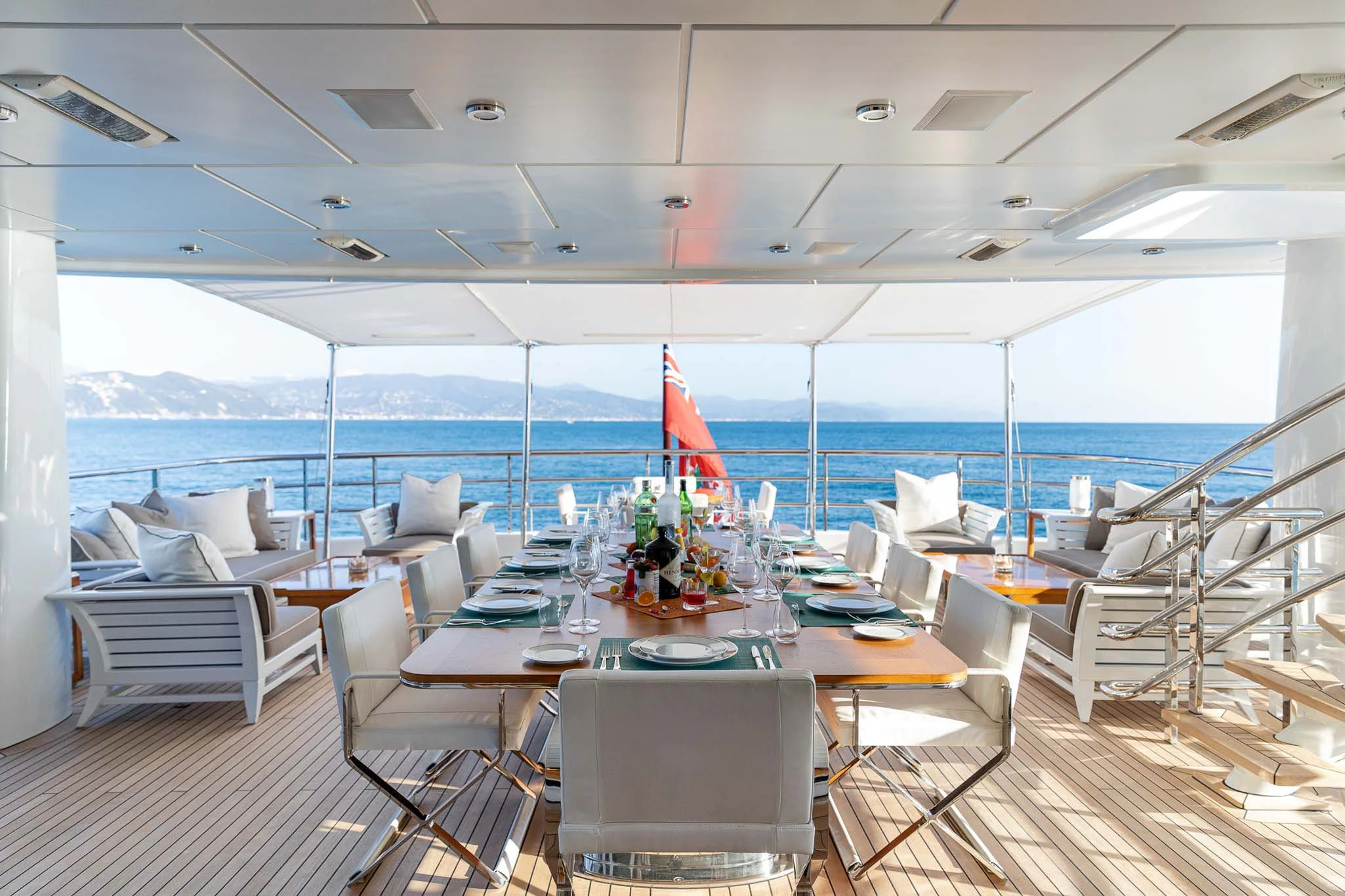 a room with a table chairs and a large body of water aboard REVELRY Yacht for Sale