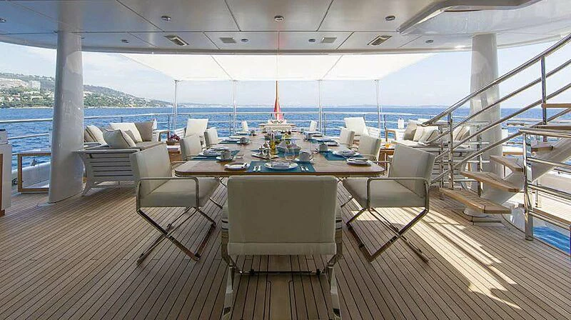 a large room with a table and chairs aboard REVELRY Yacht for Sale