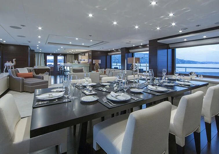 a large dining table in a room aboard REVELRY Yacht for Sale