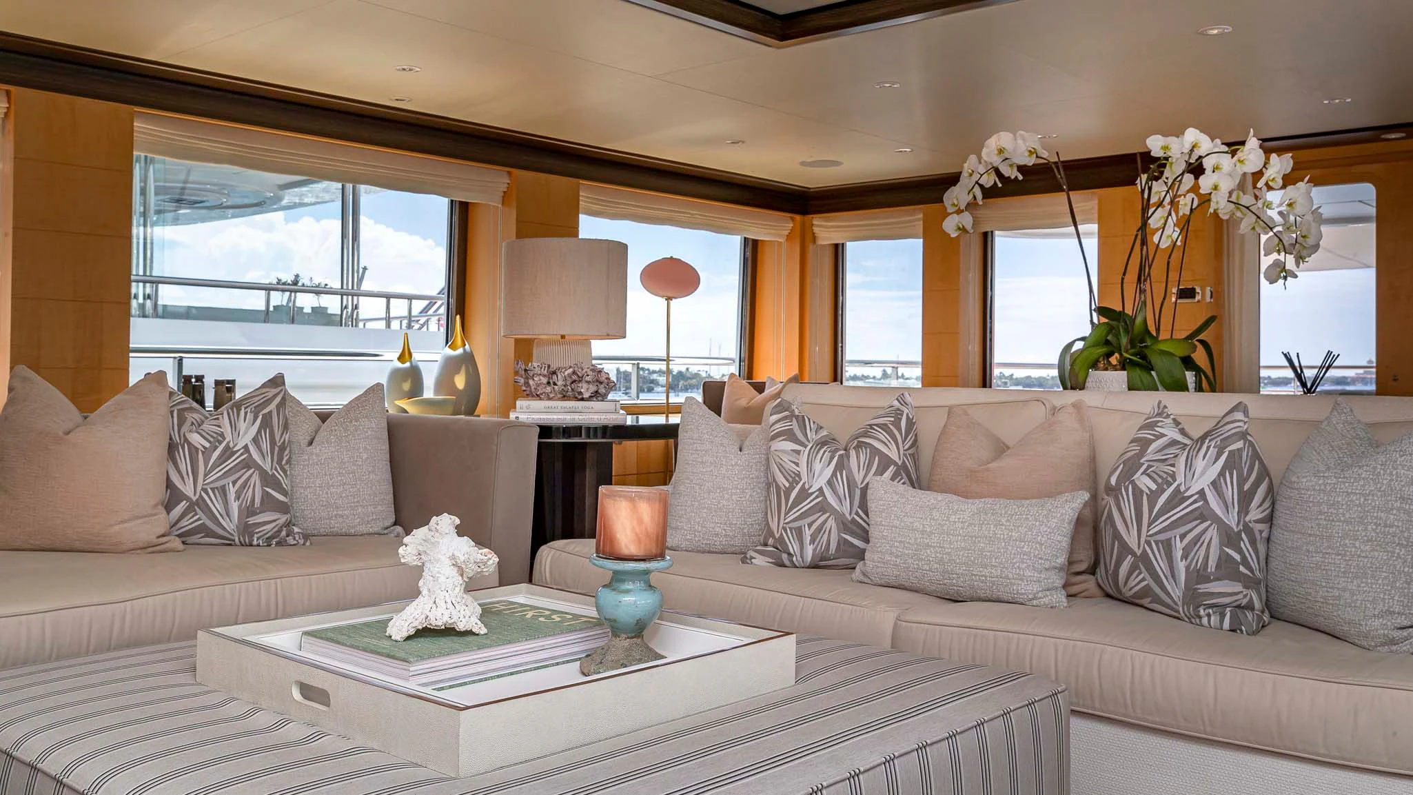 a living room with a large sofa and a coffee table aboard REVELRY Yacht for Sale