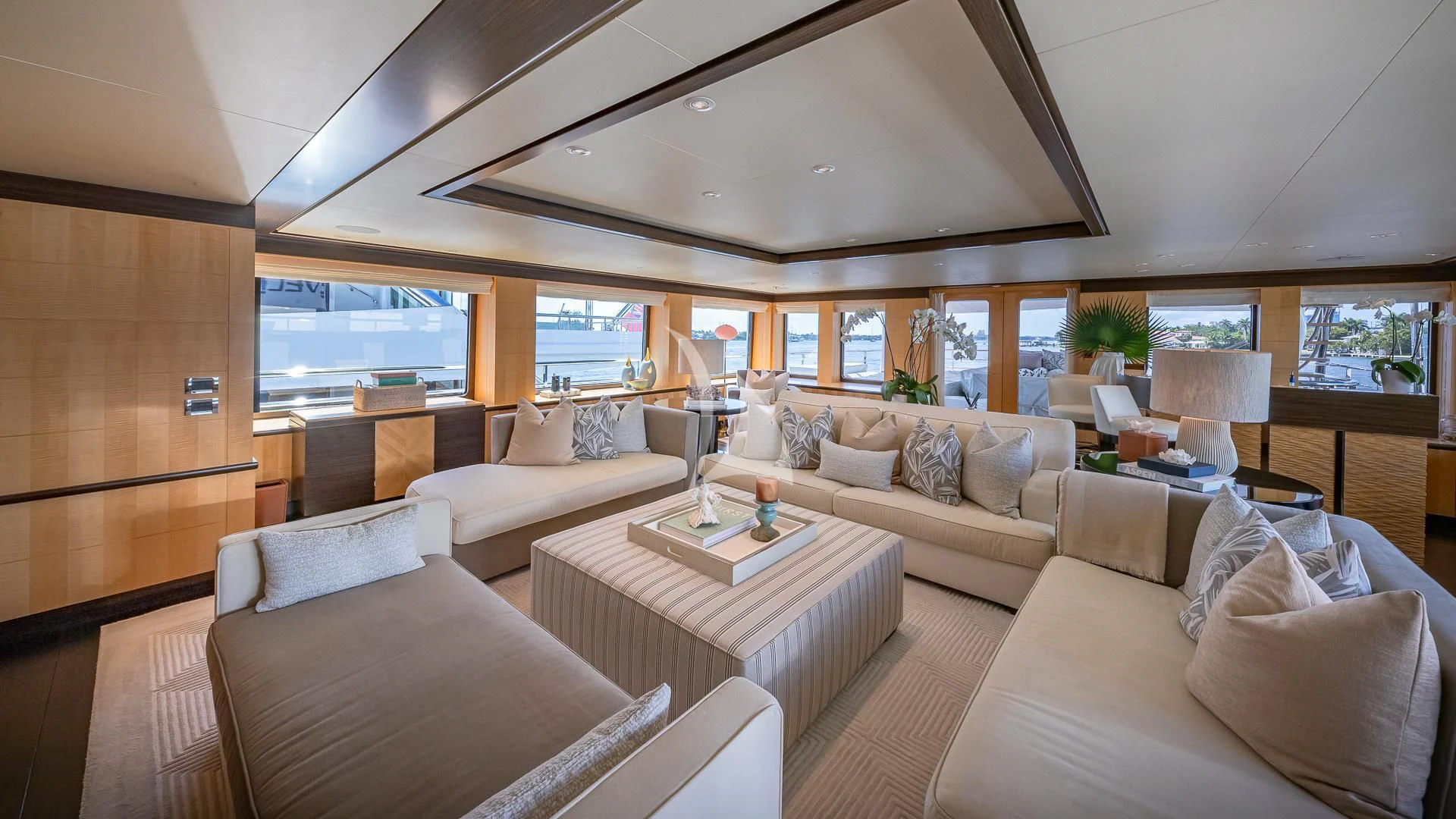 a room with couches and a table aboard REVELRY Yacht for Sale