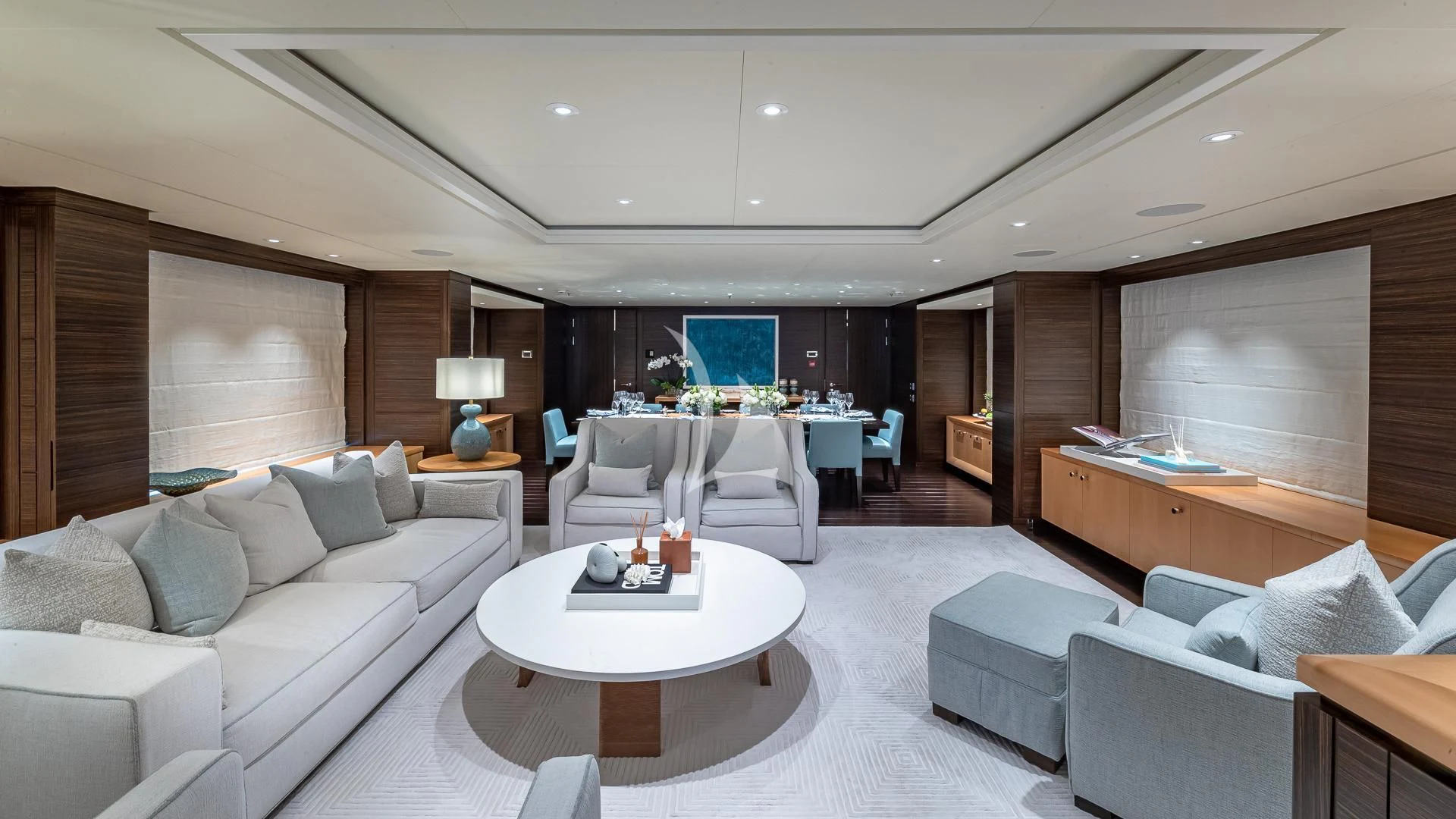 a living room with a white couch and a table aboard REVELRY Yacht for Sale