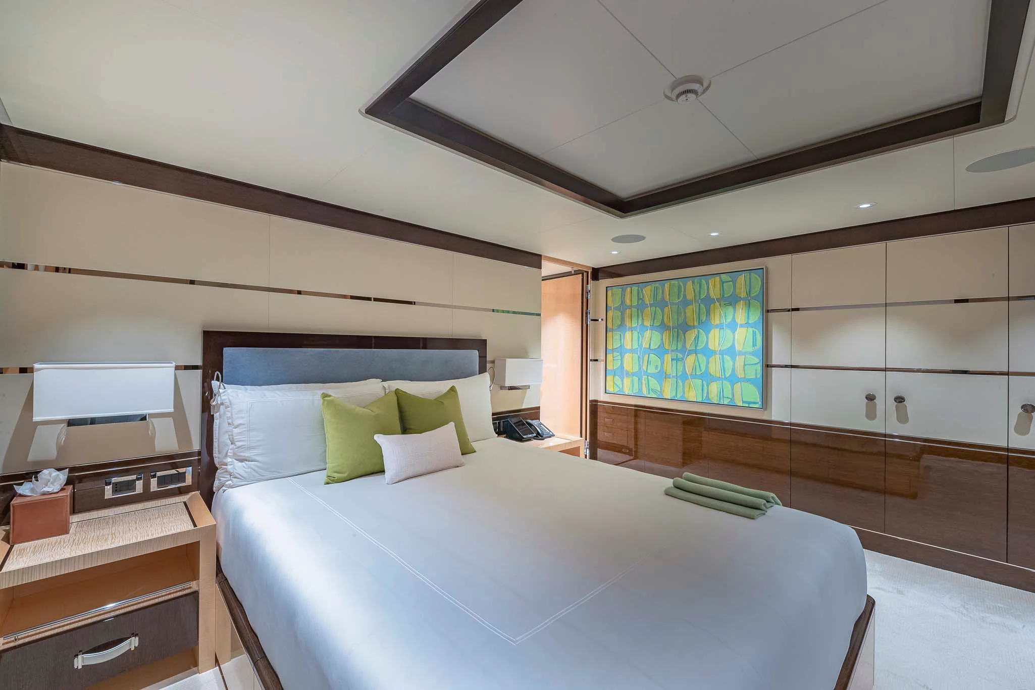 a bedroom with a bed and a desk aboard REVELRY Yacht for Sale