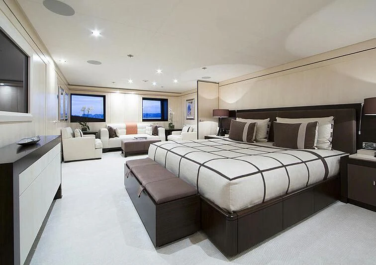a large bedroom with a bed and a tv aboard REVELRY Yacht for Sale