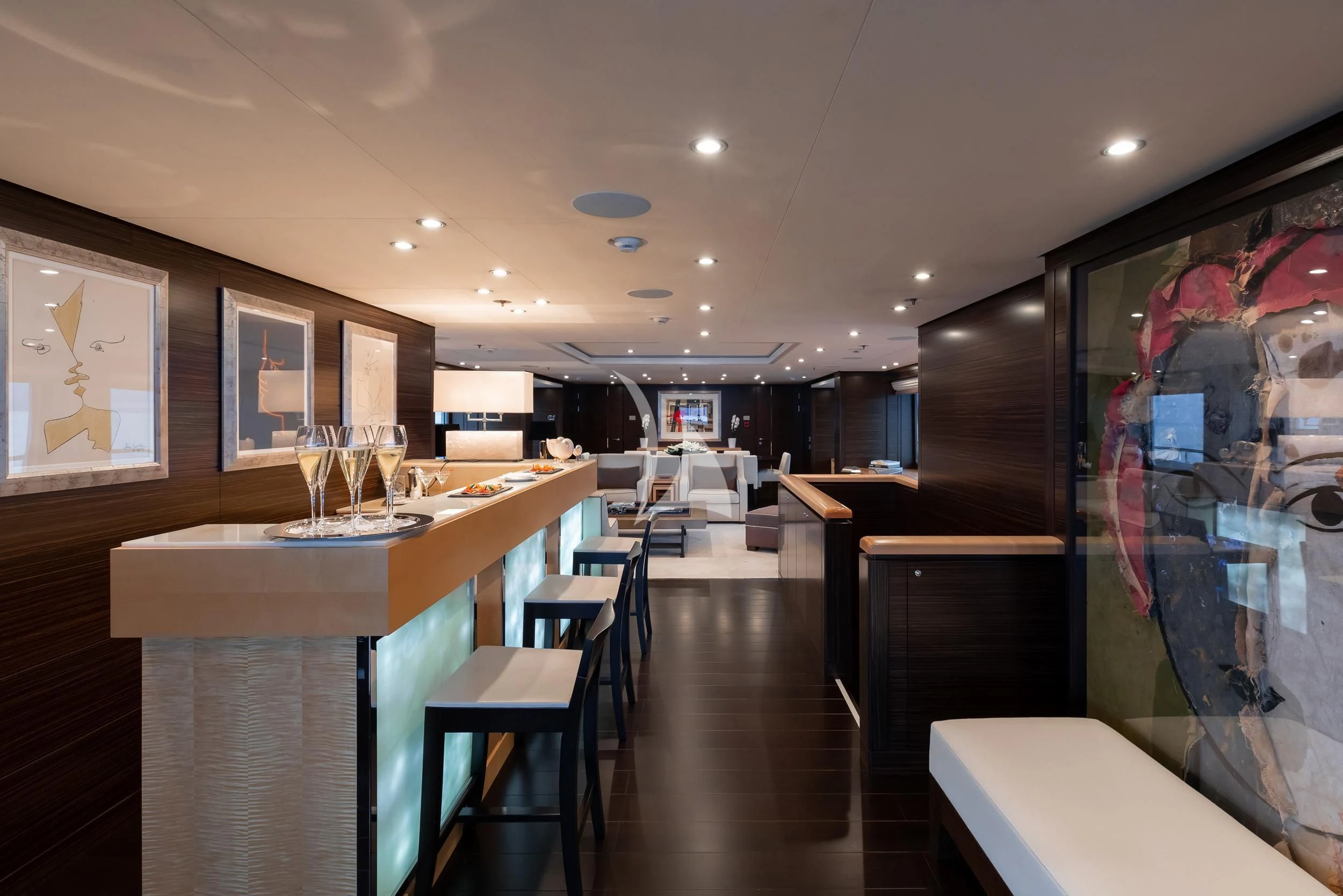 a restaurant with a counter and chairs aboard REVELRY Yacht for Sale