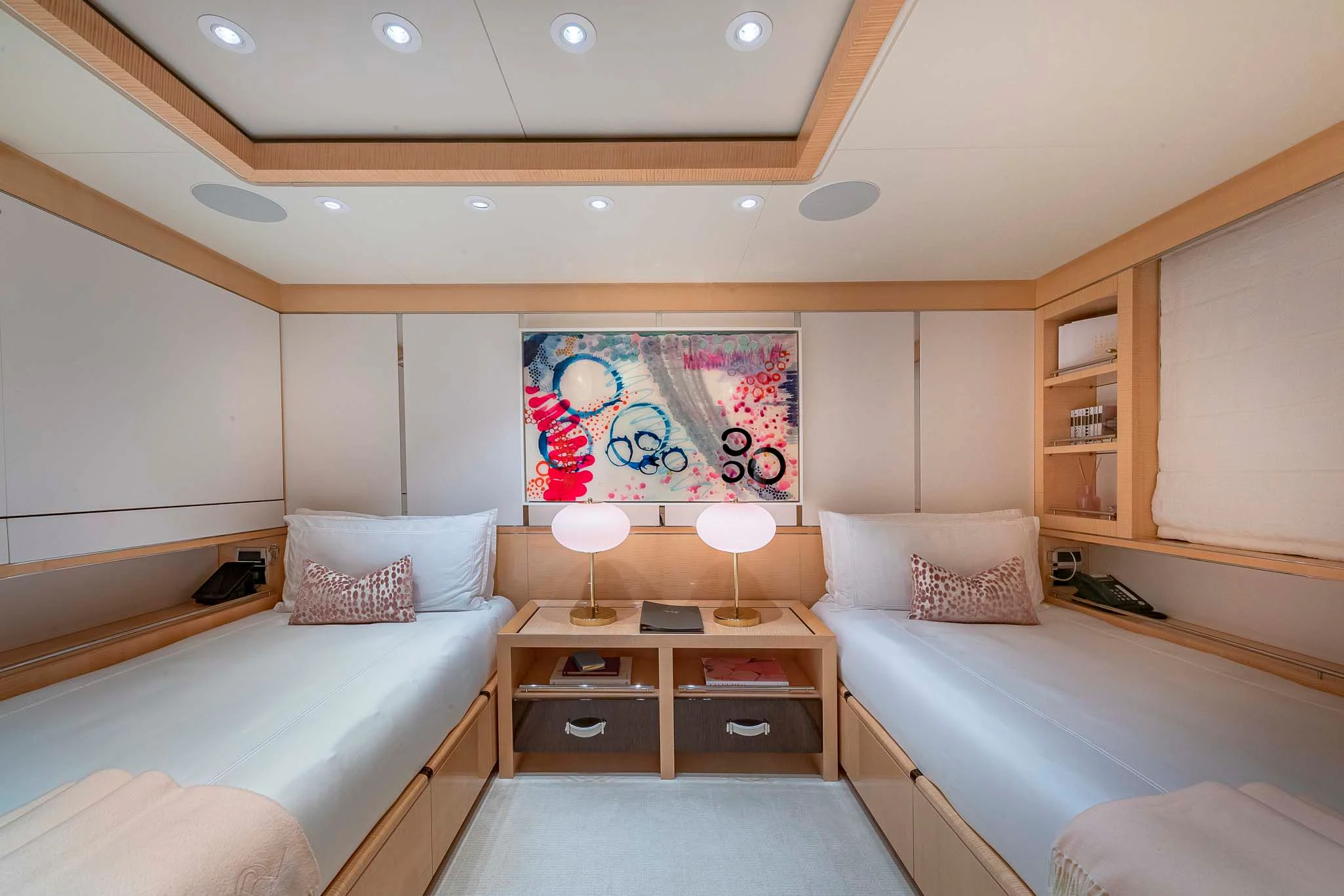 a bedroom with a bed and a desk aboard REVELRY Yacht for Sale