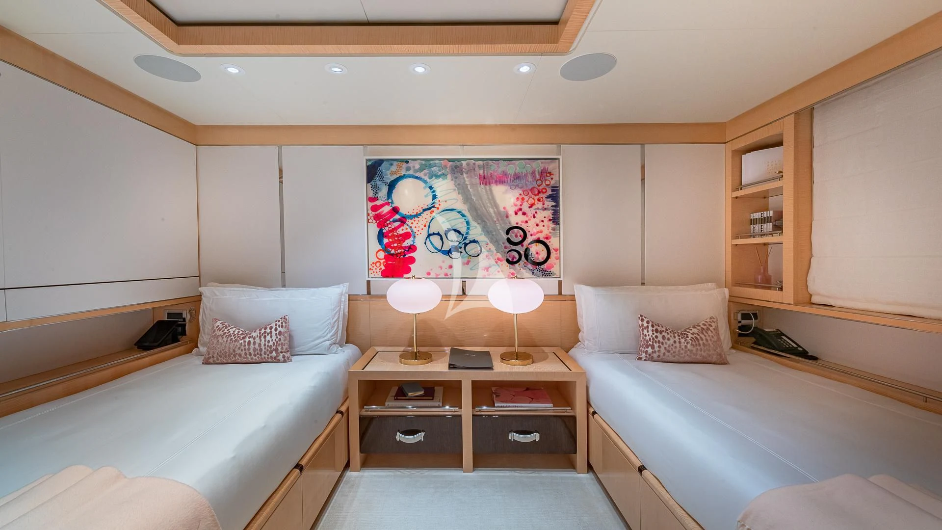 a bedroom with a bed and a desk aboard REVELRY Yacht for Sale