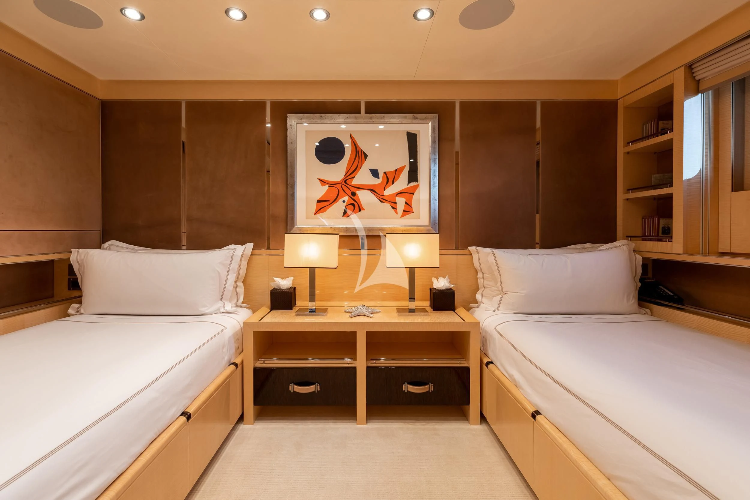 a room with two beds and a shelf with a painting on it aboard REVELRY Yacht for Sale
