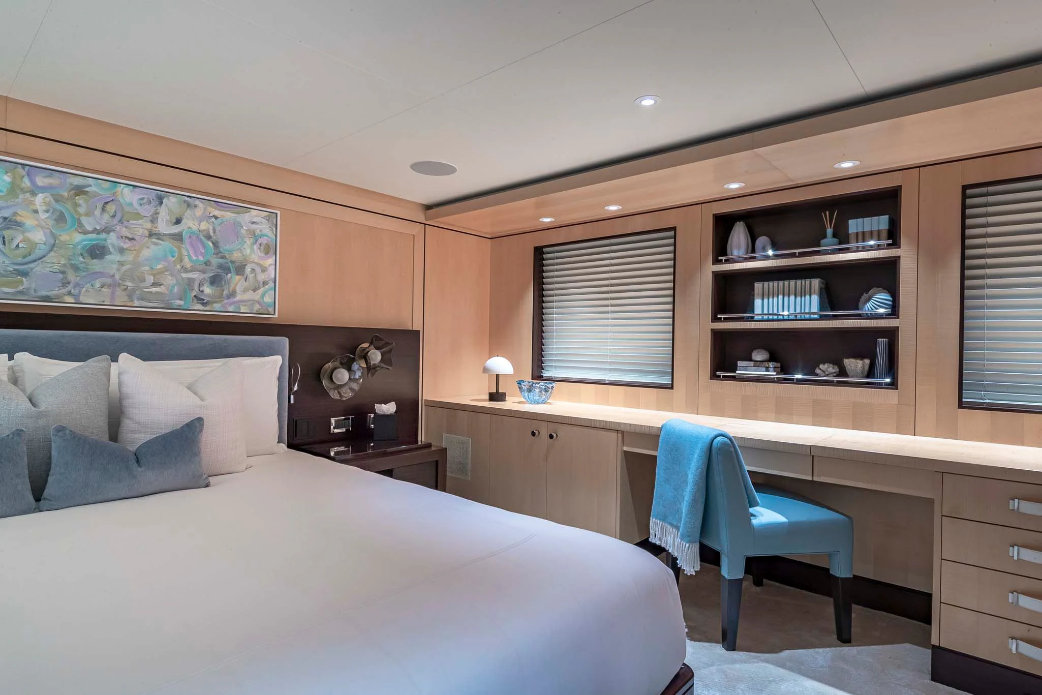 a bedroom with a bed and desk aboard REVELRY Yacht for Sale