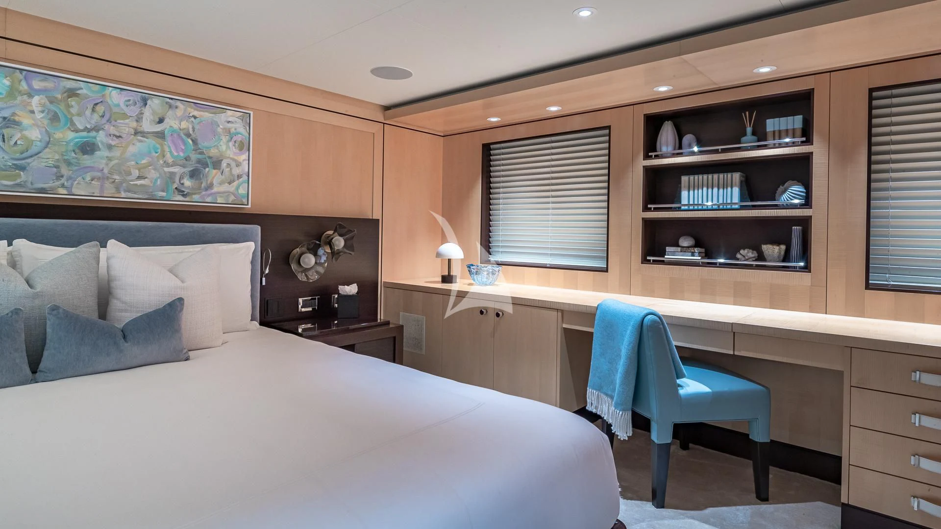 a bedroom with a bed and a desk aboard REVELRY Yacht for Sale