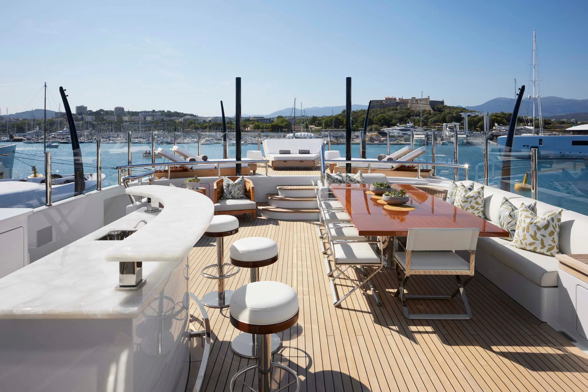 a deck with tables and chairs on it aboard REVELRY Yacht for Sale