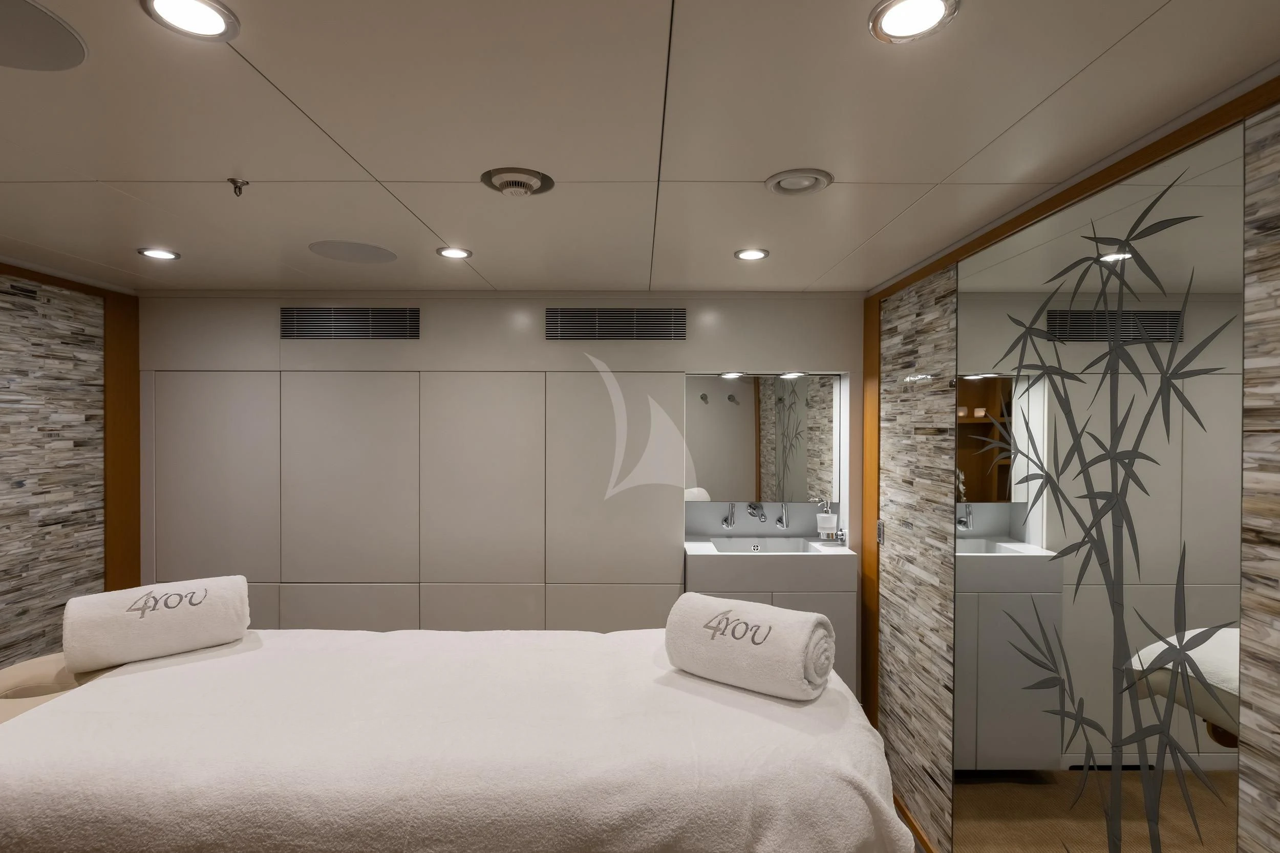 a bedroom with a bed and a mirror aboard REVELRY Yacht for Sale