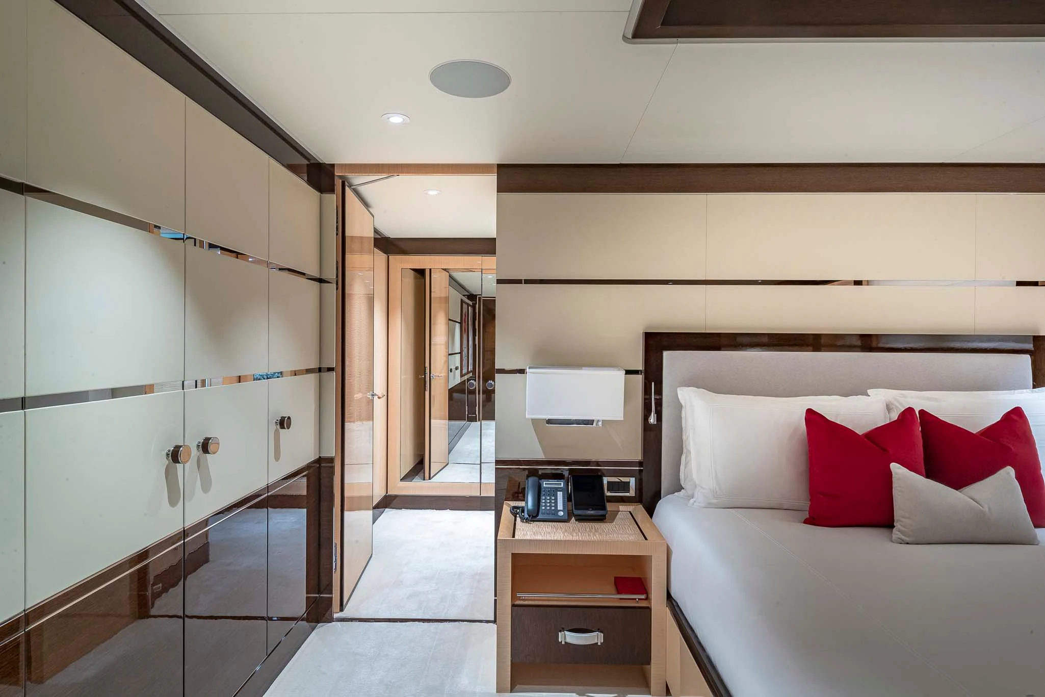 a room with a bed and a desk aboard REVELRY Yacht for Sale