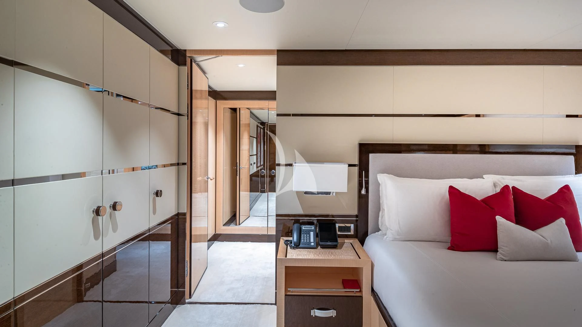 a room with a bed and a desk aboard REVELRY Yacht for Sale