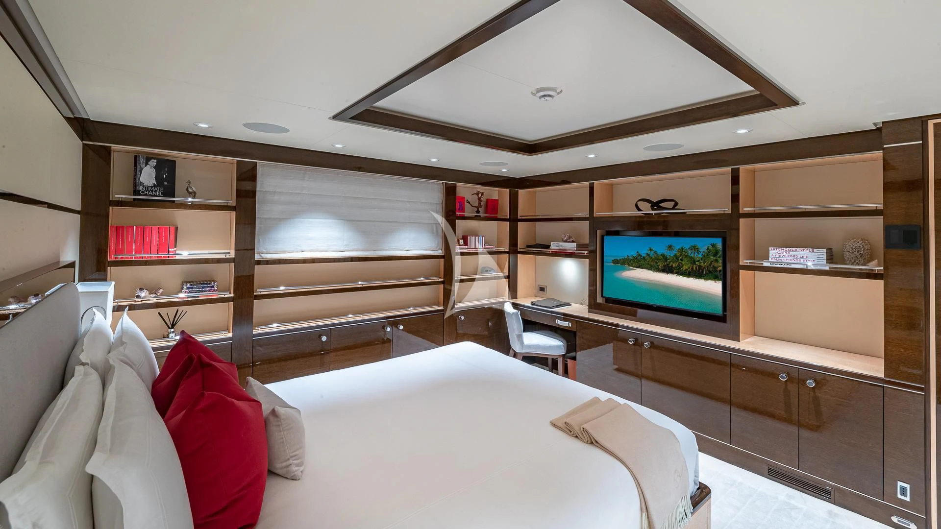 a room with a tv and a bed aboard REVELRY Yacht for Sale