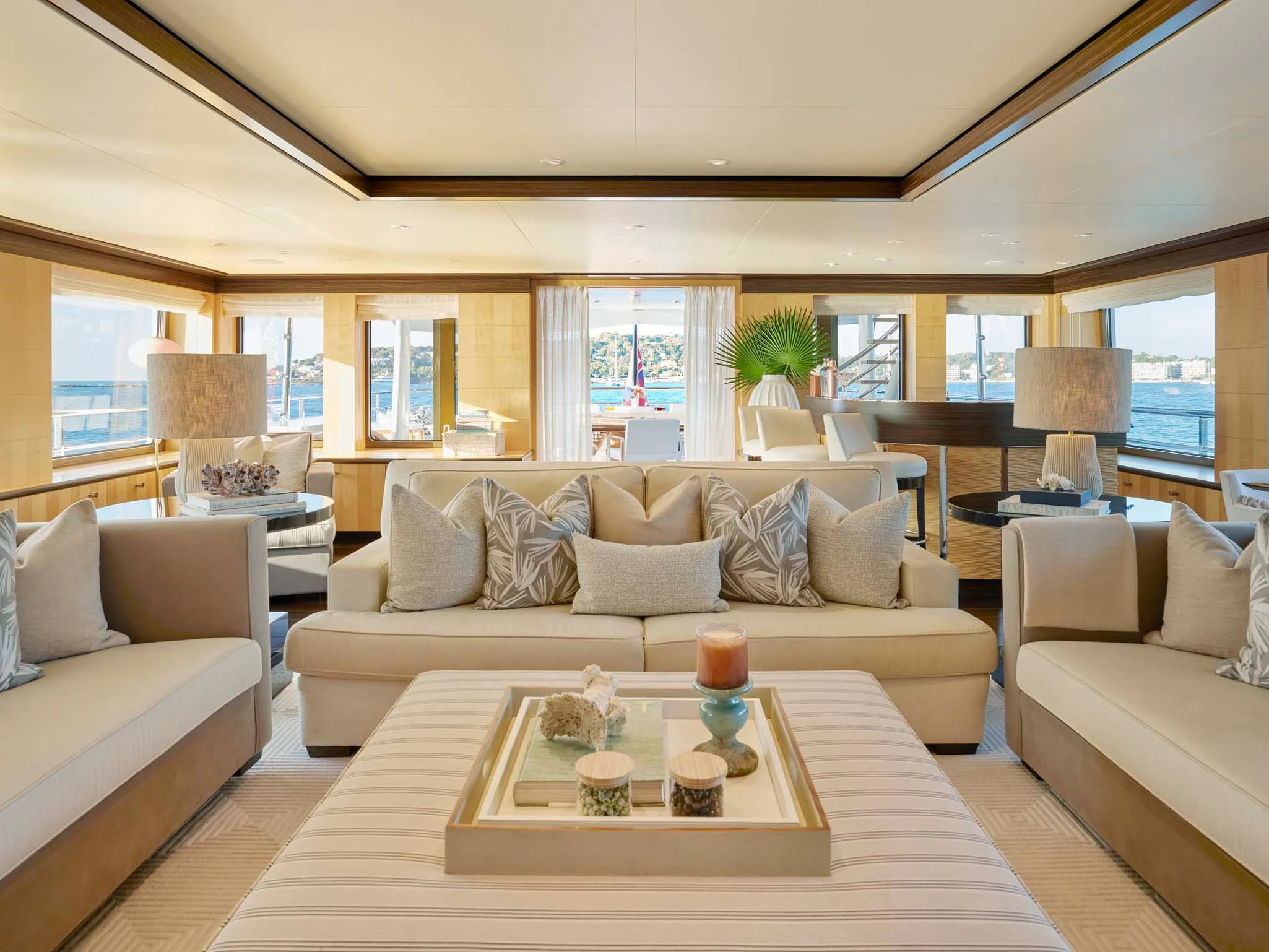 a living room with a large sofa and a coffee table aboard REVELRY Yacht for Sale