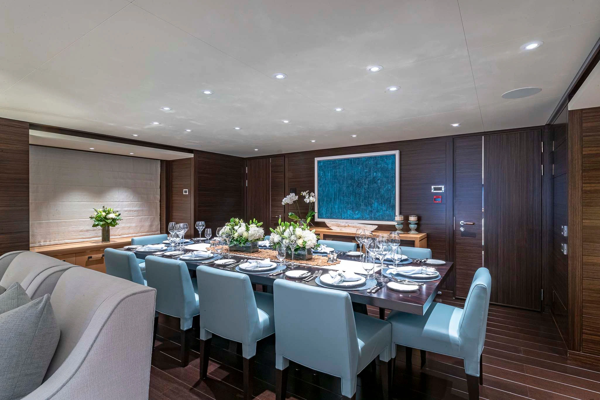 a large room with a table and chairs aboard REVELRY Yacht for Sale