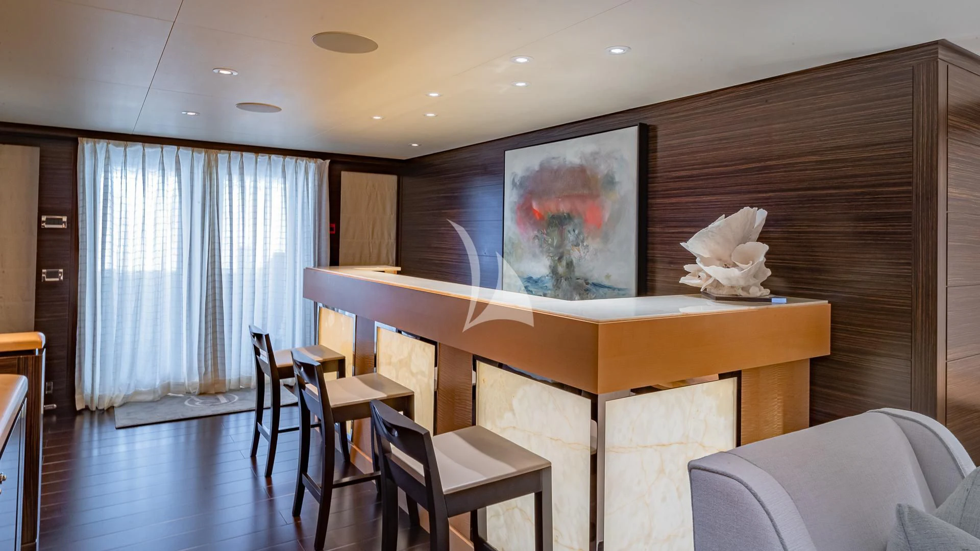 a room with tables and chairs aboard REVELRY Yacht for Sale