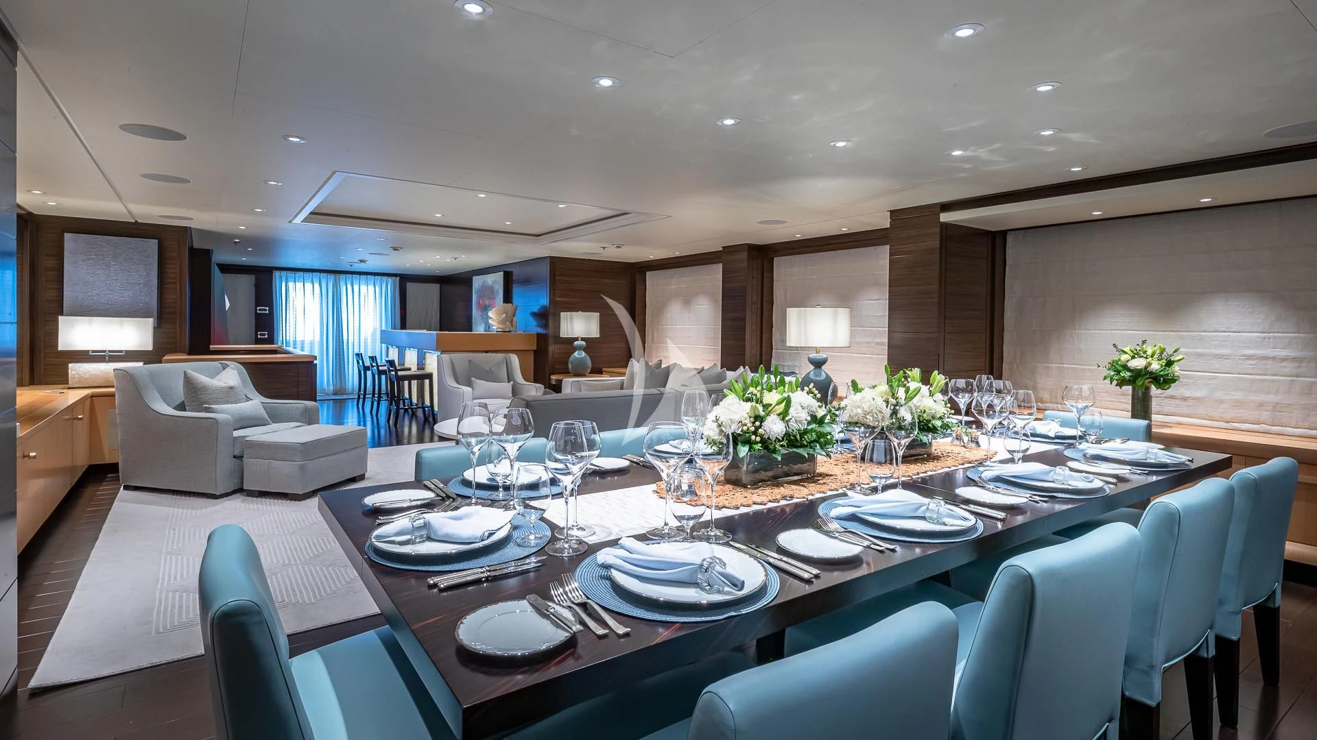 a large dining room with a large table set for dinner aboard REVELRY Yacht for Sale