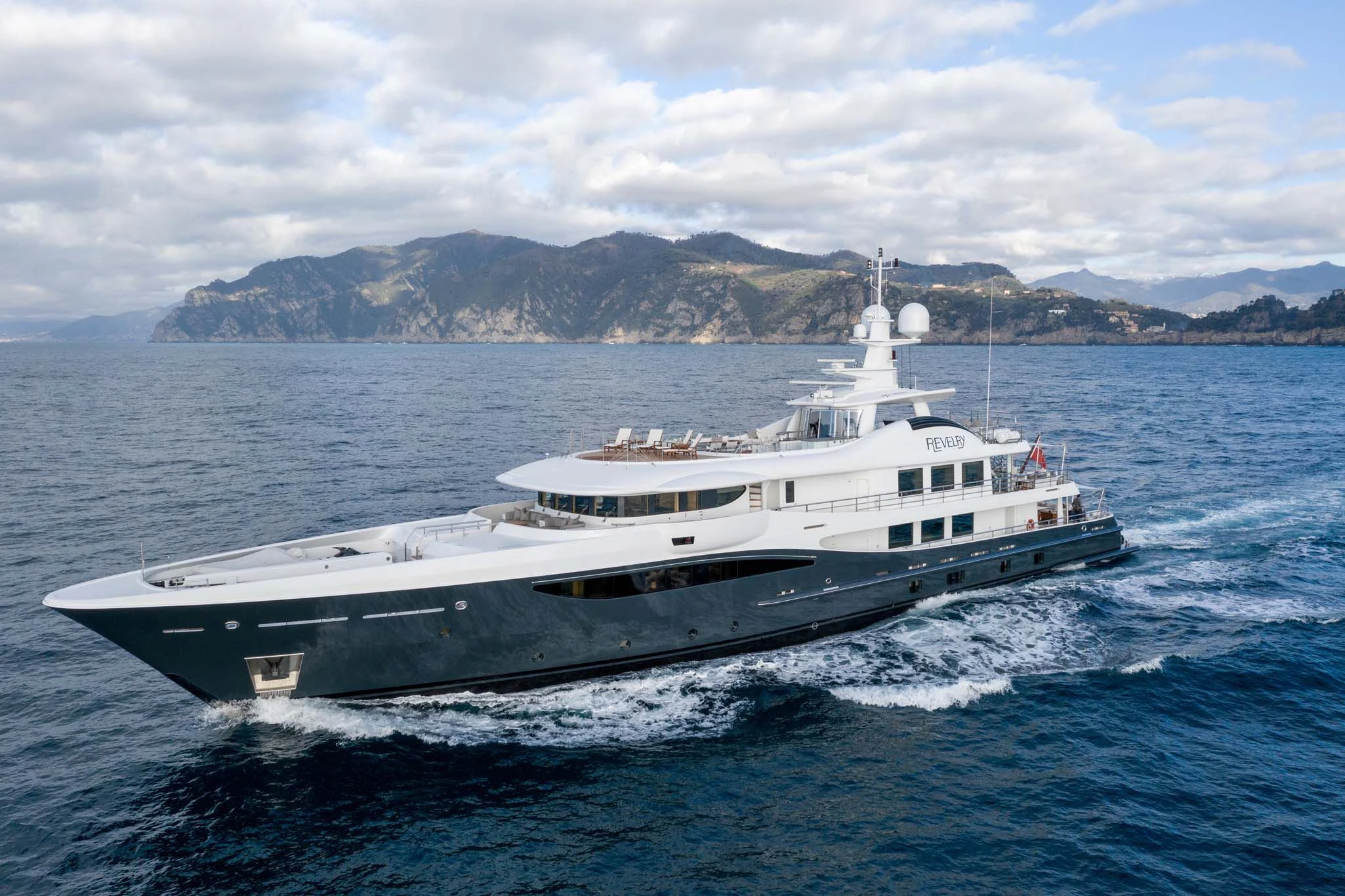 a large white boat in the water aboard REVELRY Yacht for Sale