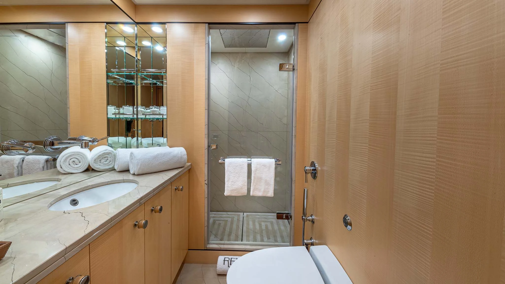 a bathroom with a glass shower aboard REVELRY Yacht for Sale