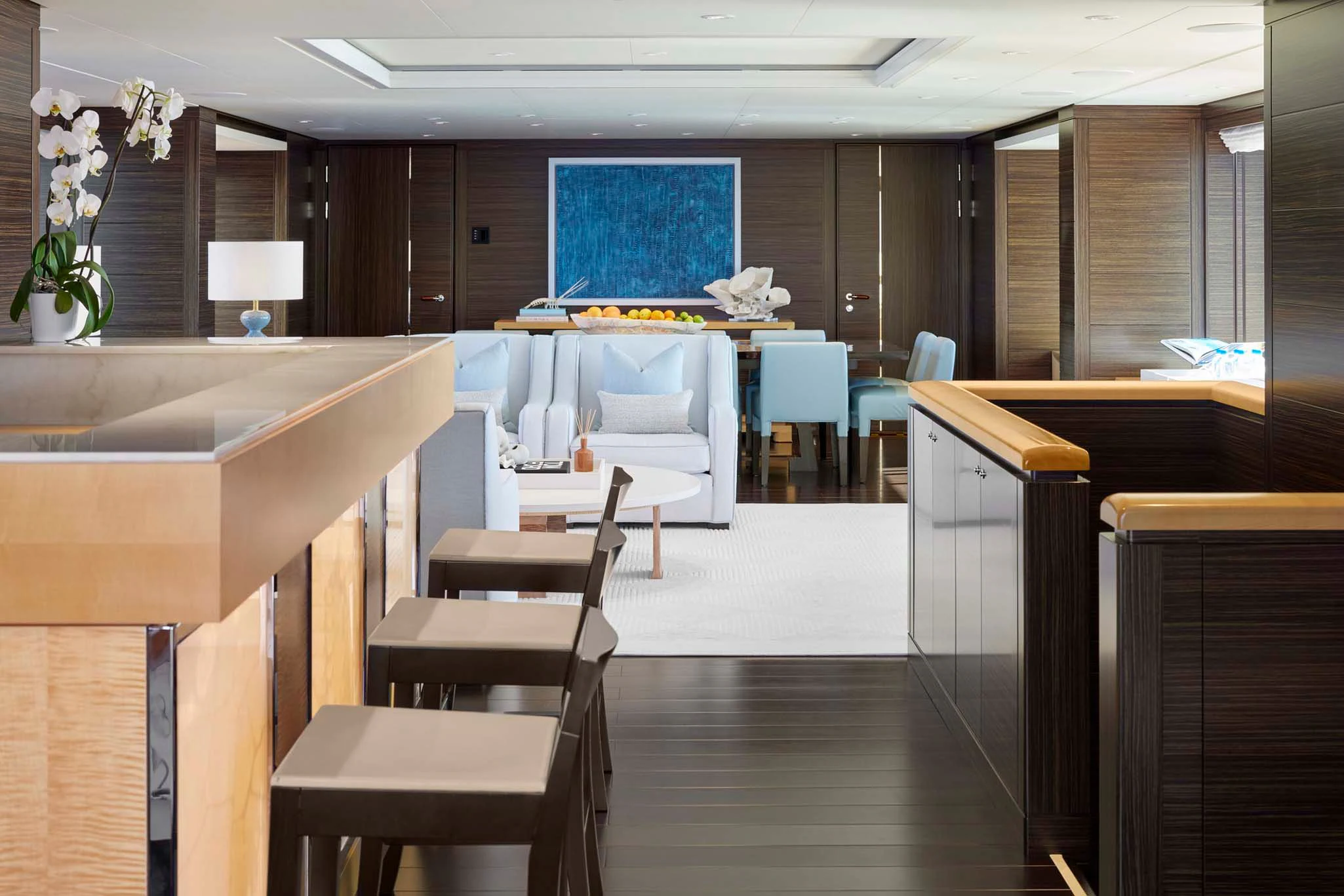 a room with tables and chairs aboard REVELRY Yacht for Sale