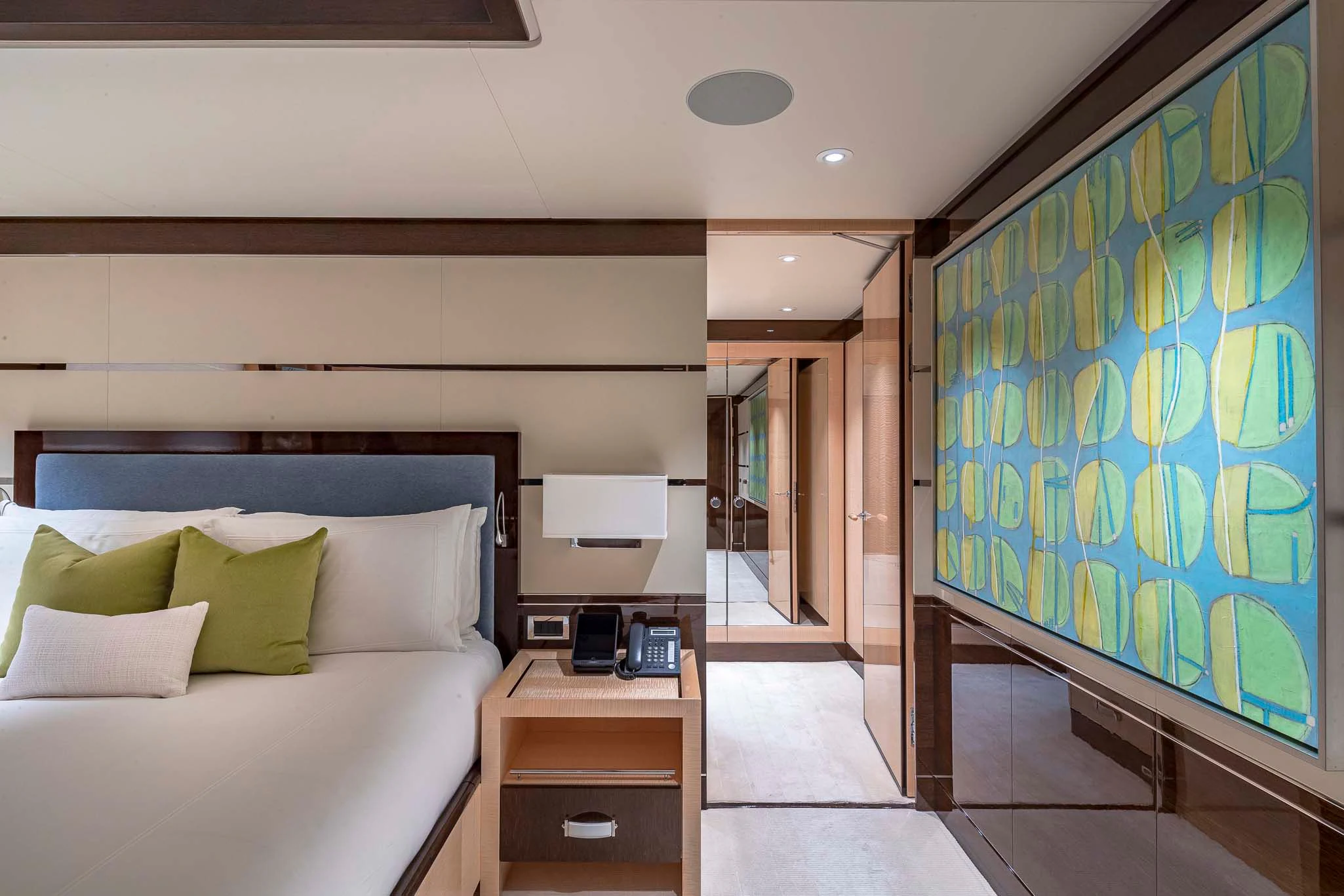 a bedroom with a bed and a desk aboard REVELRY Yacht for Sale