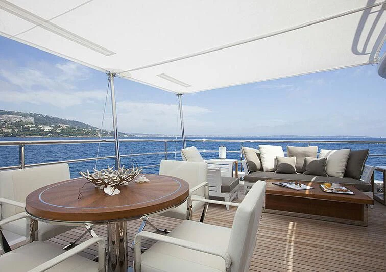 a table and chairs on a boat aboard REVELRY Yacht for Sale