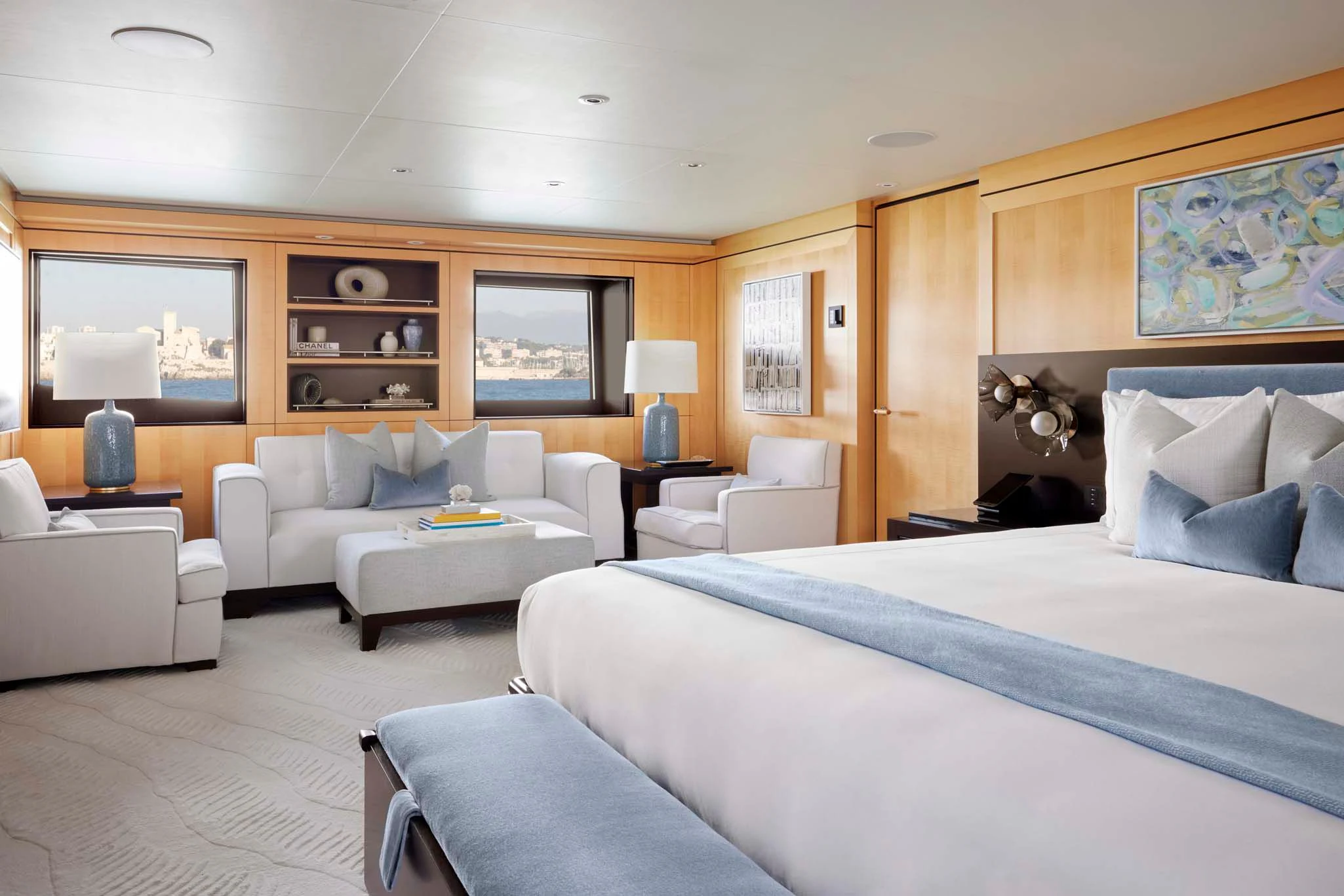 a bedroom with a bed and a couch aboard REVELRY Yacht for Sale