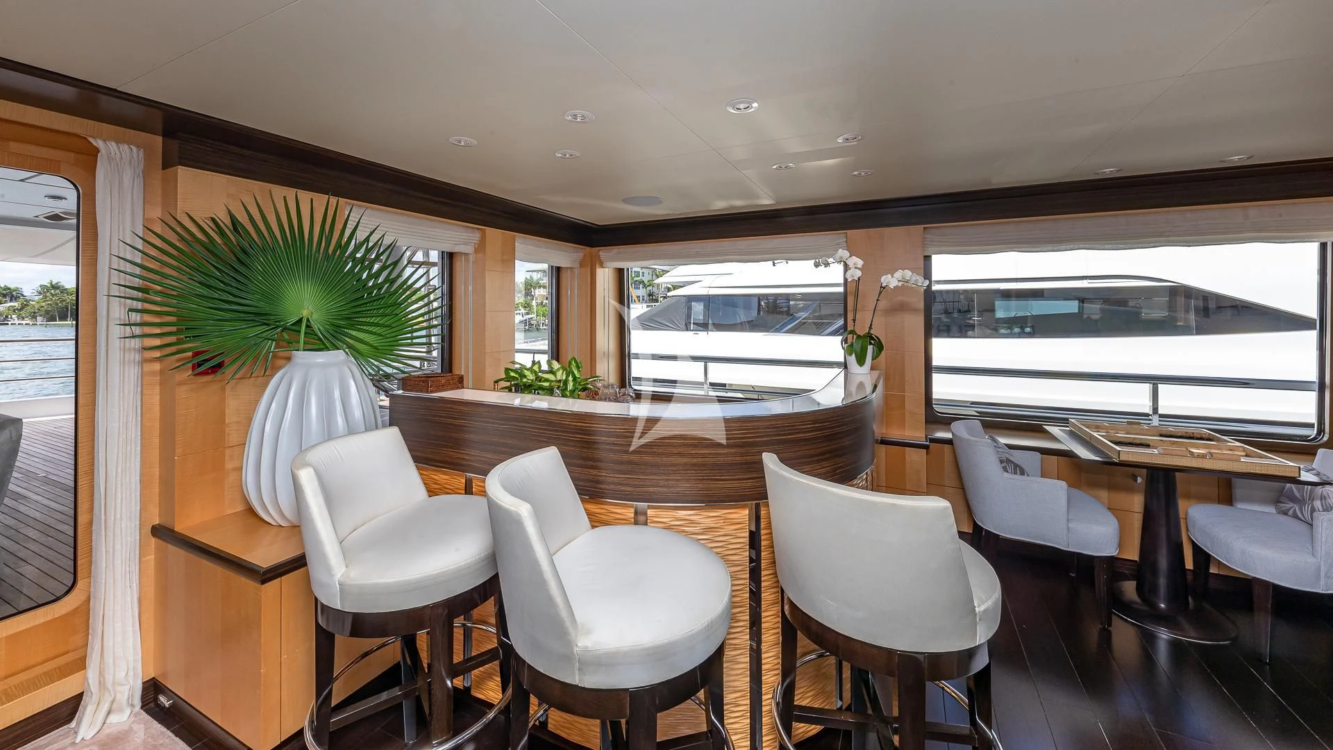 a room with tables and chairs aboard REVELRY Yacht for Sale