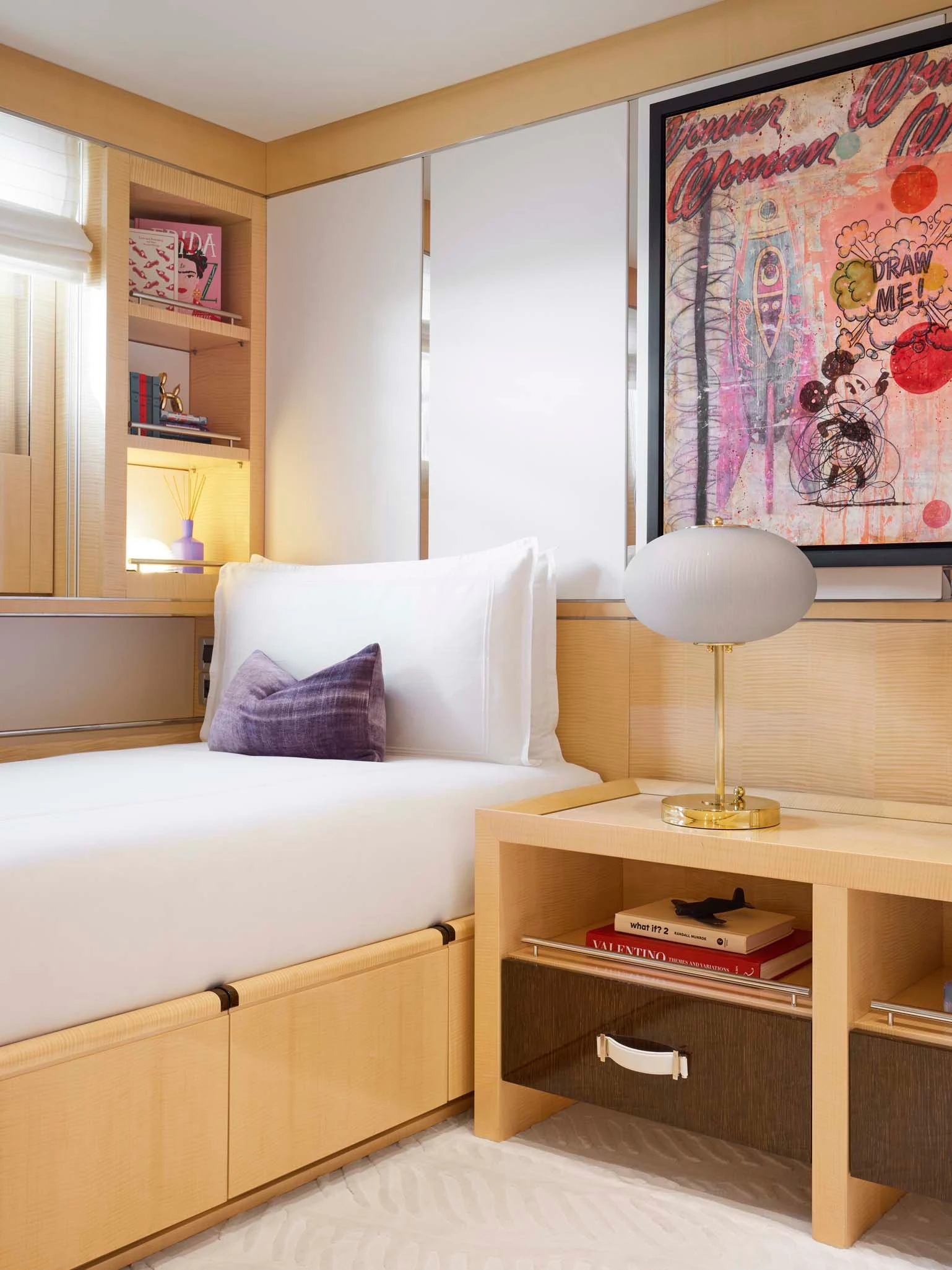 a bedroom with a white couch and a lamp on a table aboard REVELRY Yacht for Sale