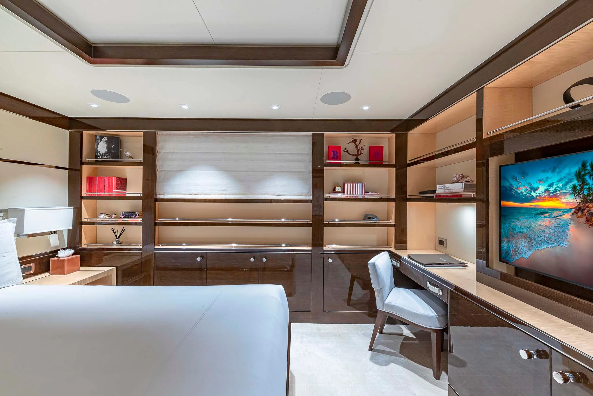 a room with a tv and a bed aboard REVELRY Yacht for Sale