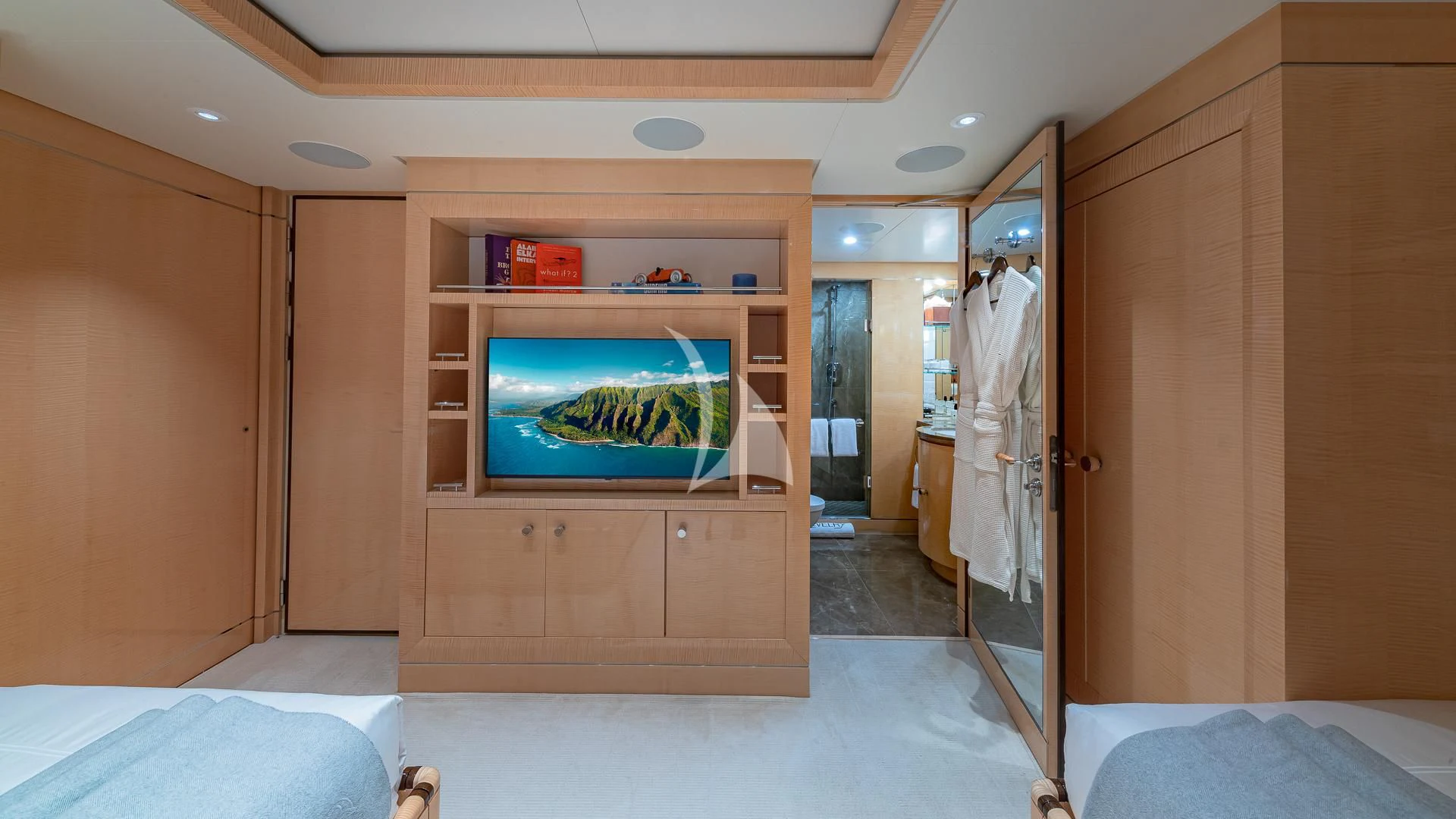 a room with a tv and a bed aboard REVELRY Yacht for Sale
