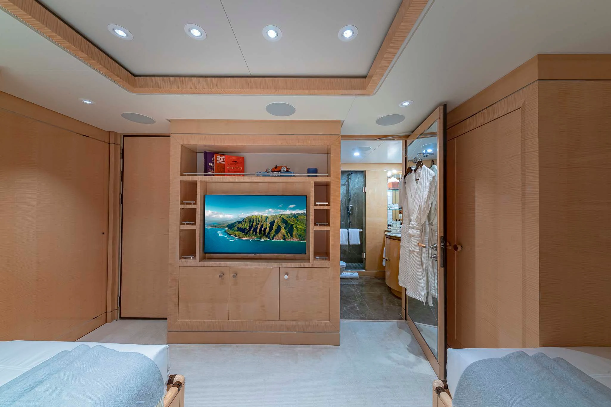a room with a tv and a bed aboard REVELRY Yacht for Sale