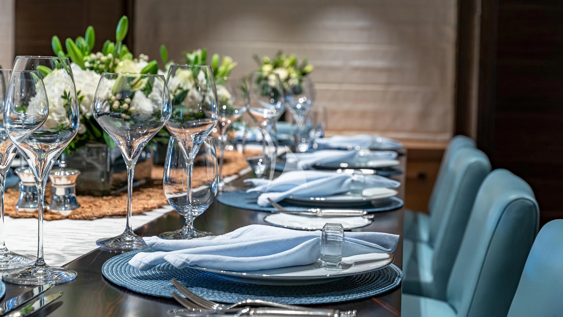 a table with plates and glasses aboard REVELRY Yacht for Sale