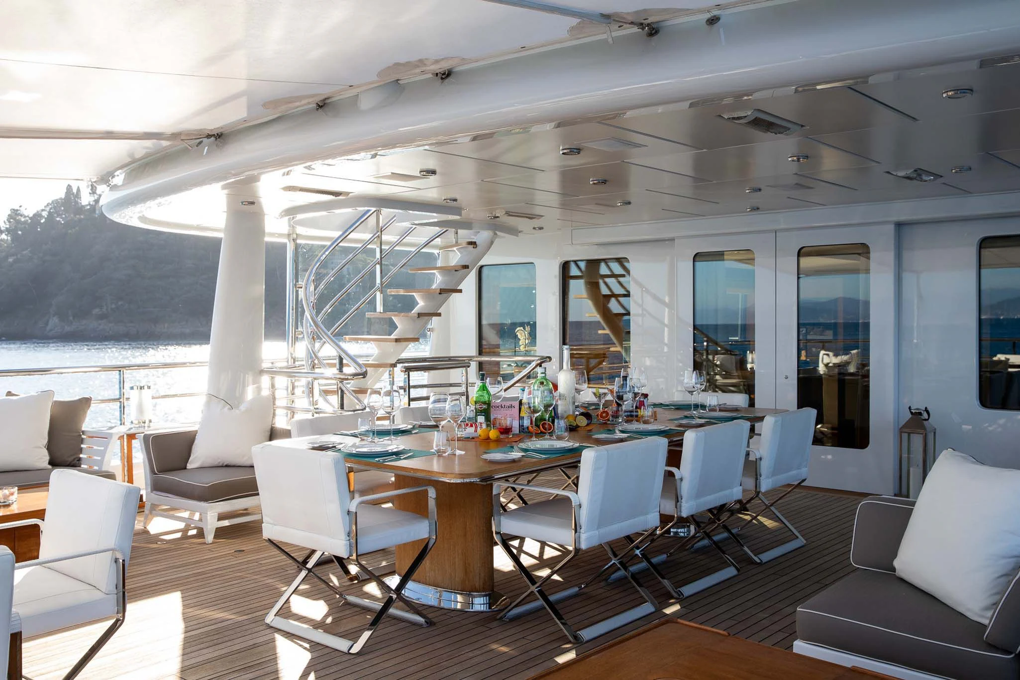 a large room with a table and chairs aboard REVELRY Yacht for Sale
