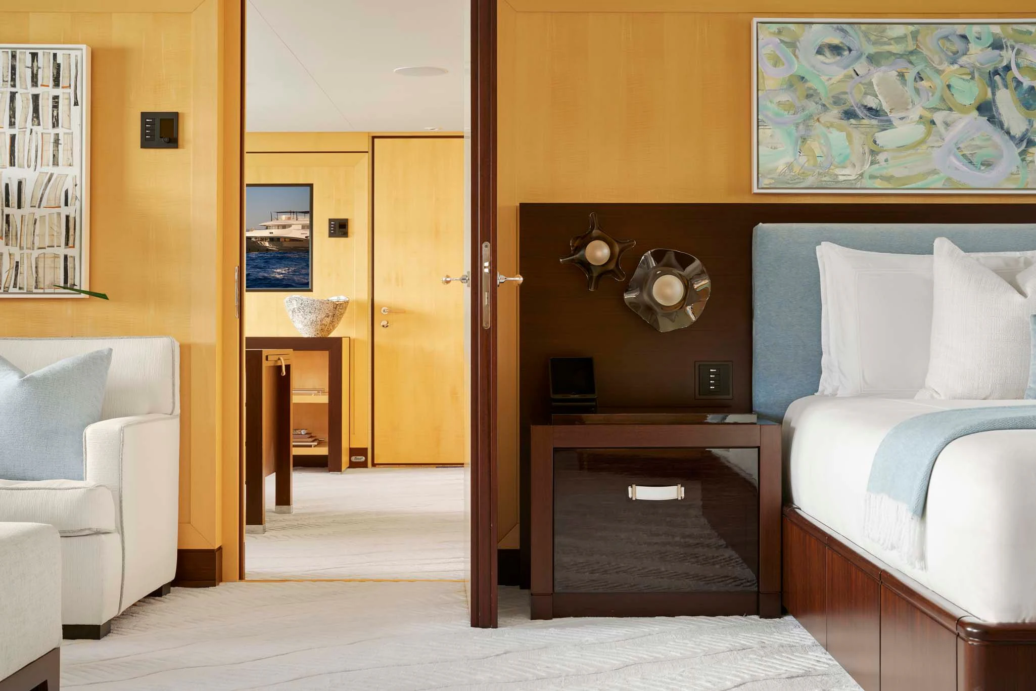 a room with a bed and a coffee table aboard REVELRY Yacht for Sale