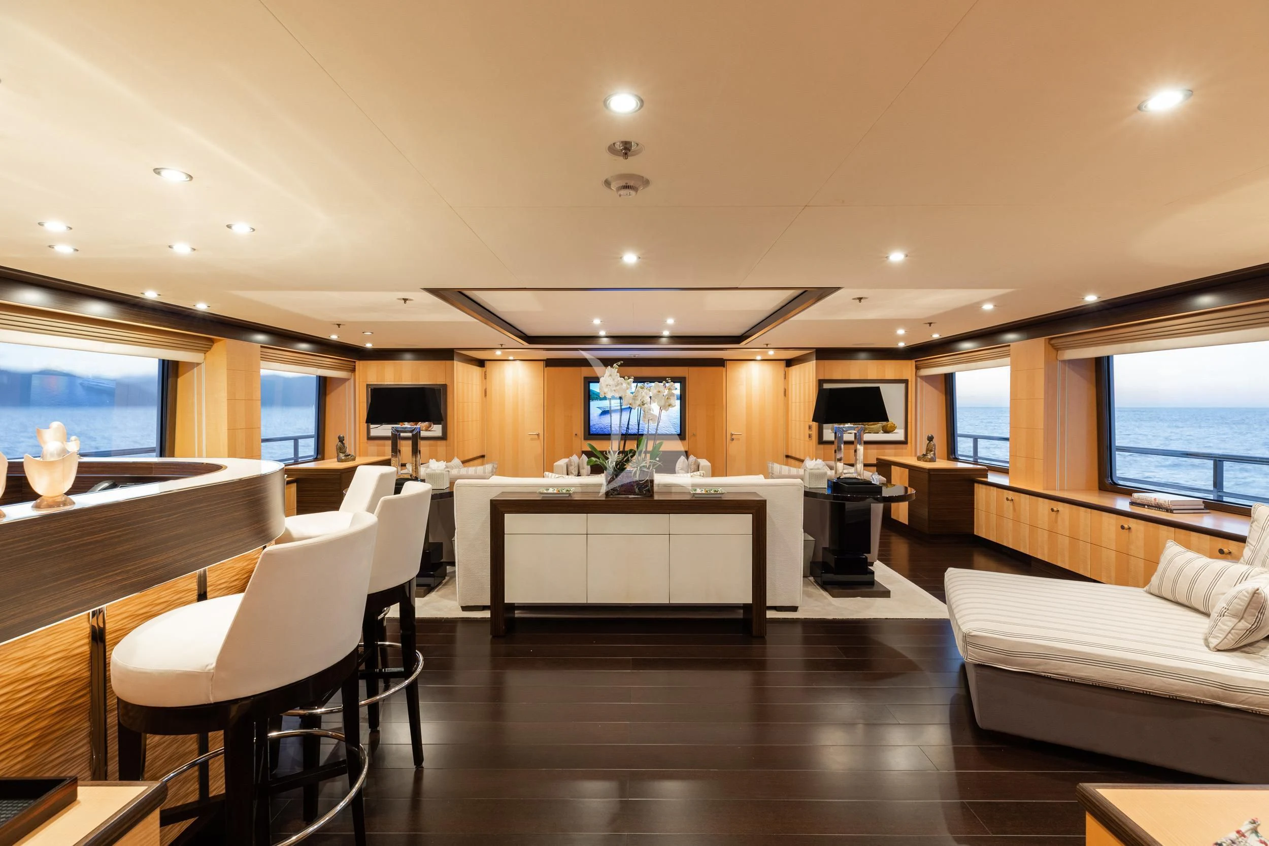 a room with a couch and a table and a tv aboard REVELRY Yacht for Sale
