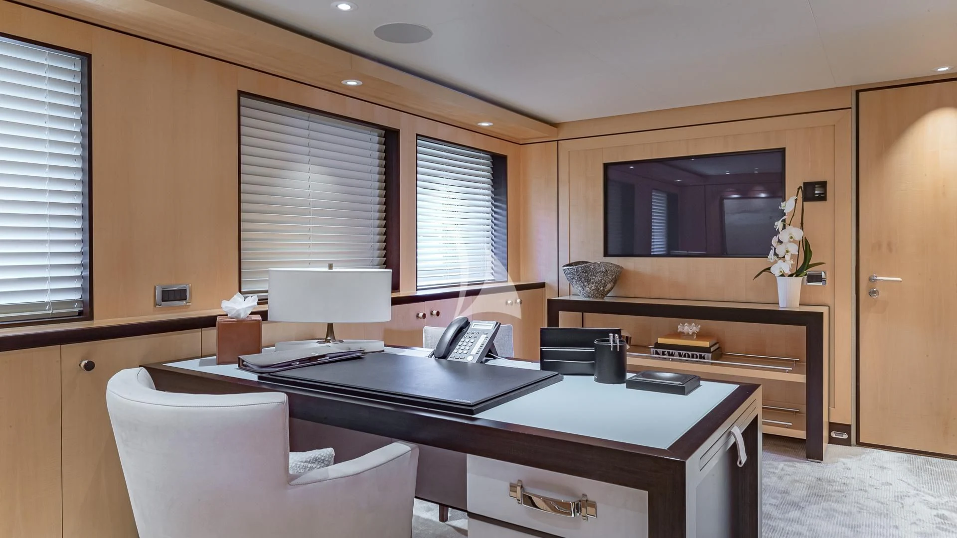 a room with a desk and a television aboard REVELRY Yacht for Sale