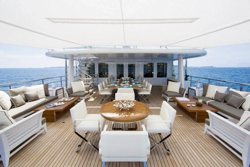 a living room with a large balcony aboard REVELRY Yacht for Sale