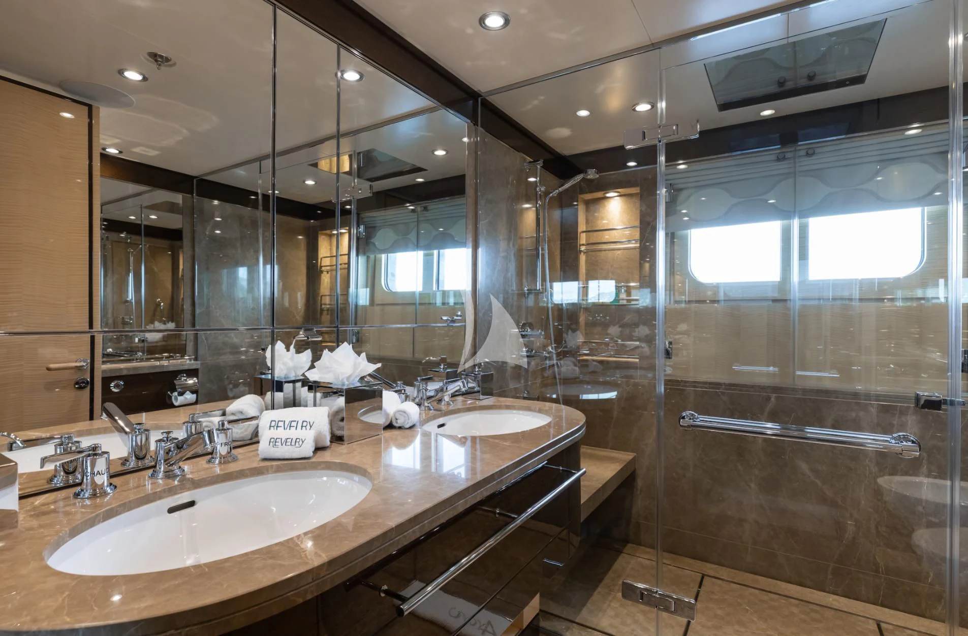 a bathroom with a large mirror aboard REVELRY Yacht for Sale