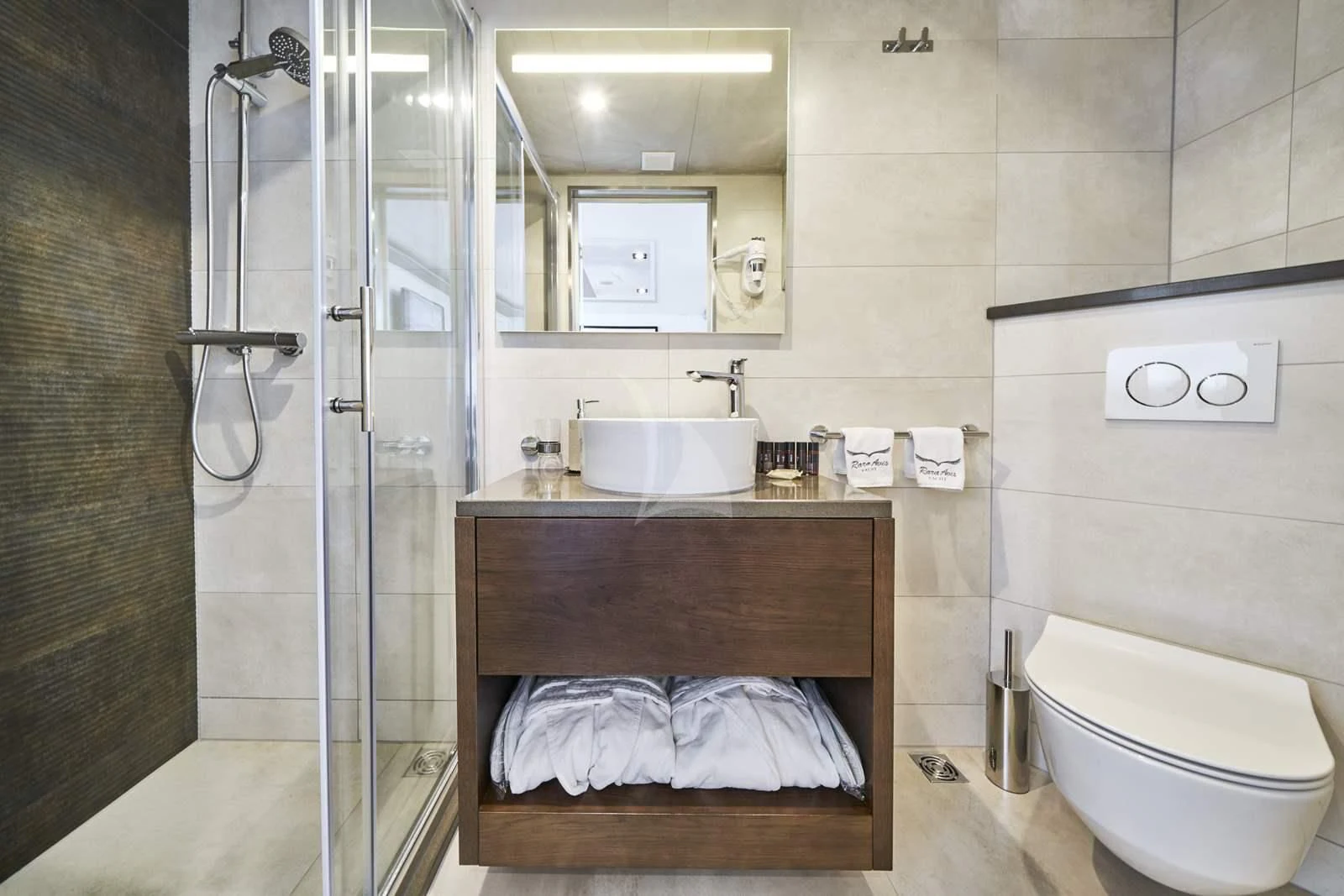 a bathroom with a sink toilet and shower aboard RARA AVIS Yacht for Charter