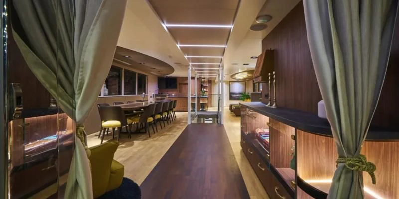 a room with tables and chairs aboard RARA AVIS Yacht for Charter